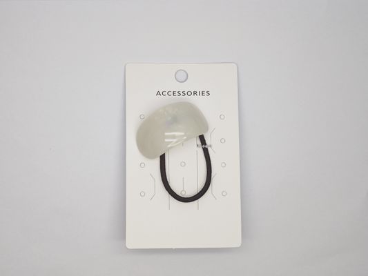 Una corbata para el cabello de acrílico blanco usada en diversas ocasiones
